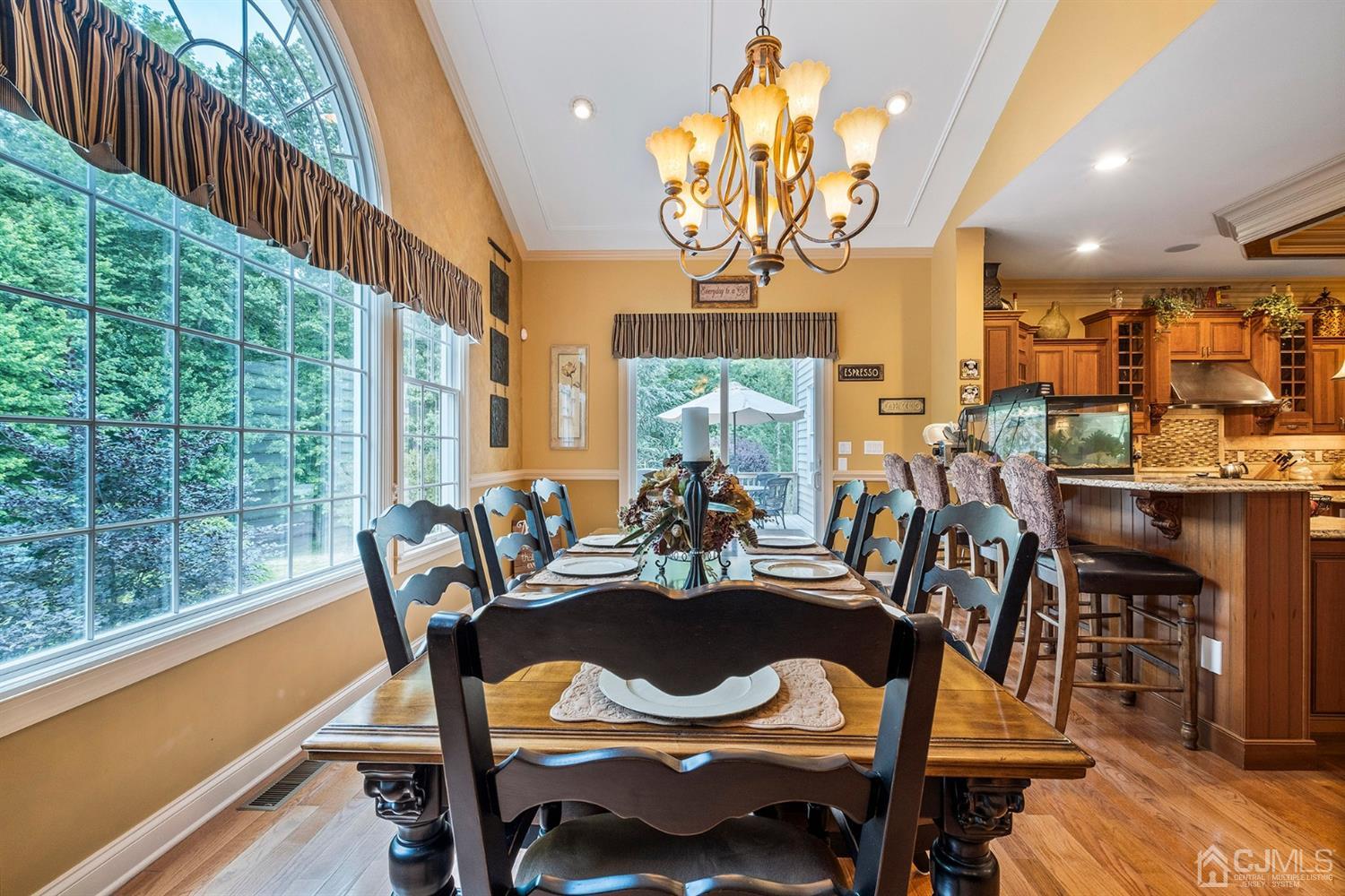 12 Horseshoe Court Monroe Township, NJ 08831 - Photo 12 of 81 a view of a dining room with furniture a chandelier and wooden floor