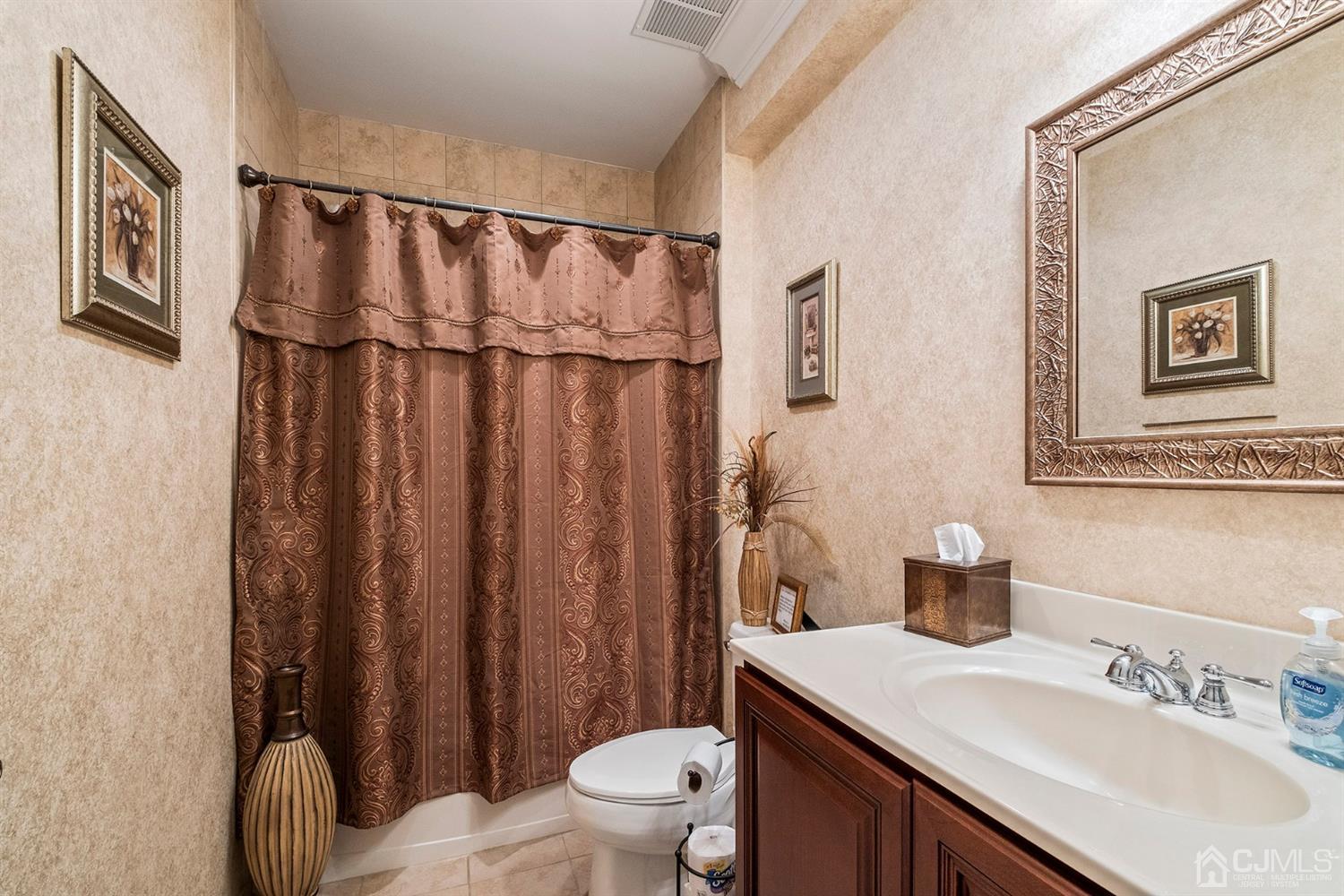 12 Horseshoe Court Monroe Township, NJ 08831 - Photo 28 of 81 a bathroom with a sink a toilet and shower curtain