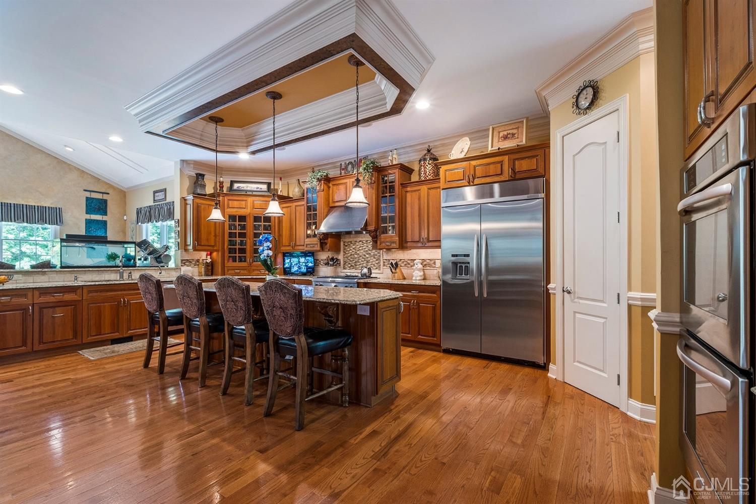 12 Horseshoe Court Monroe Township, NJ 08831 - Photo 67 of 81 a kitchen with stainless steel appliances wooden floor dining table and chairs