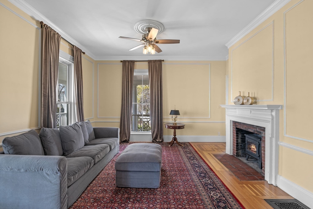 90 Puritan Road Swampscott, MA 01907 - Photo 13 of 42 a living room with furniture a fireplace and a chandelier