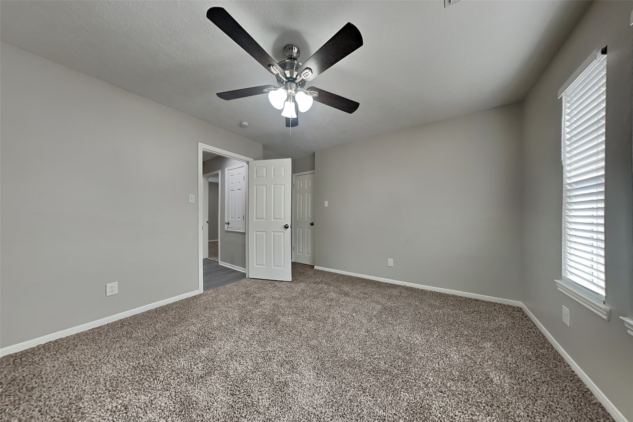 16910 Canyon Laurel Court Spring, TX 77379 - Photo 16 of 21 an empty room with a window and a fan
