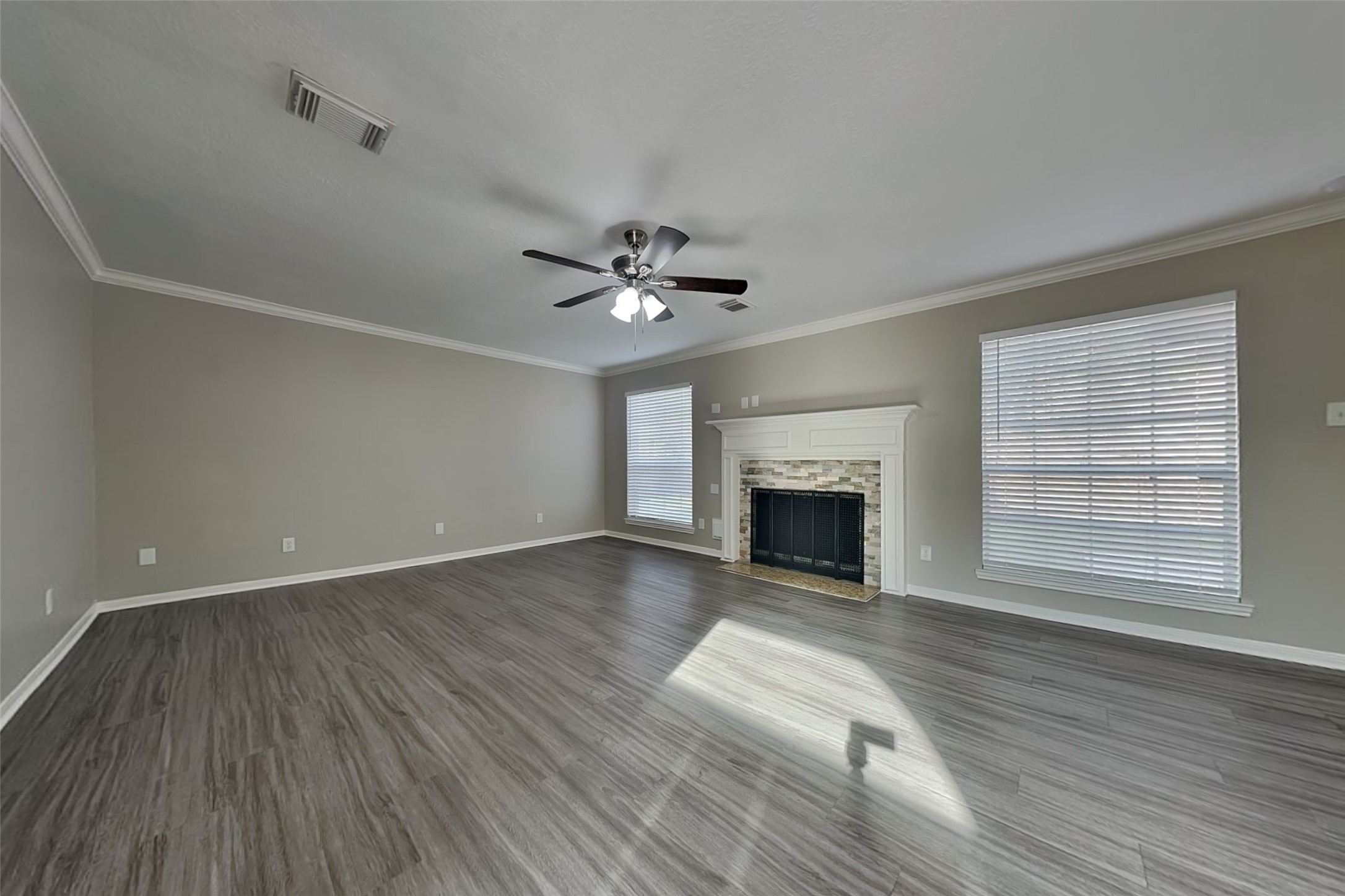 16910 Canyon Laurel Court Spring, TX 77379 - Photo 3 of 21 a view of an empty room with wooden floor fireplace and a window