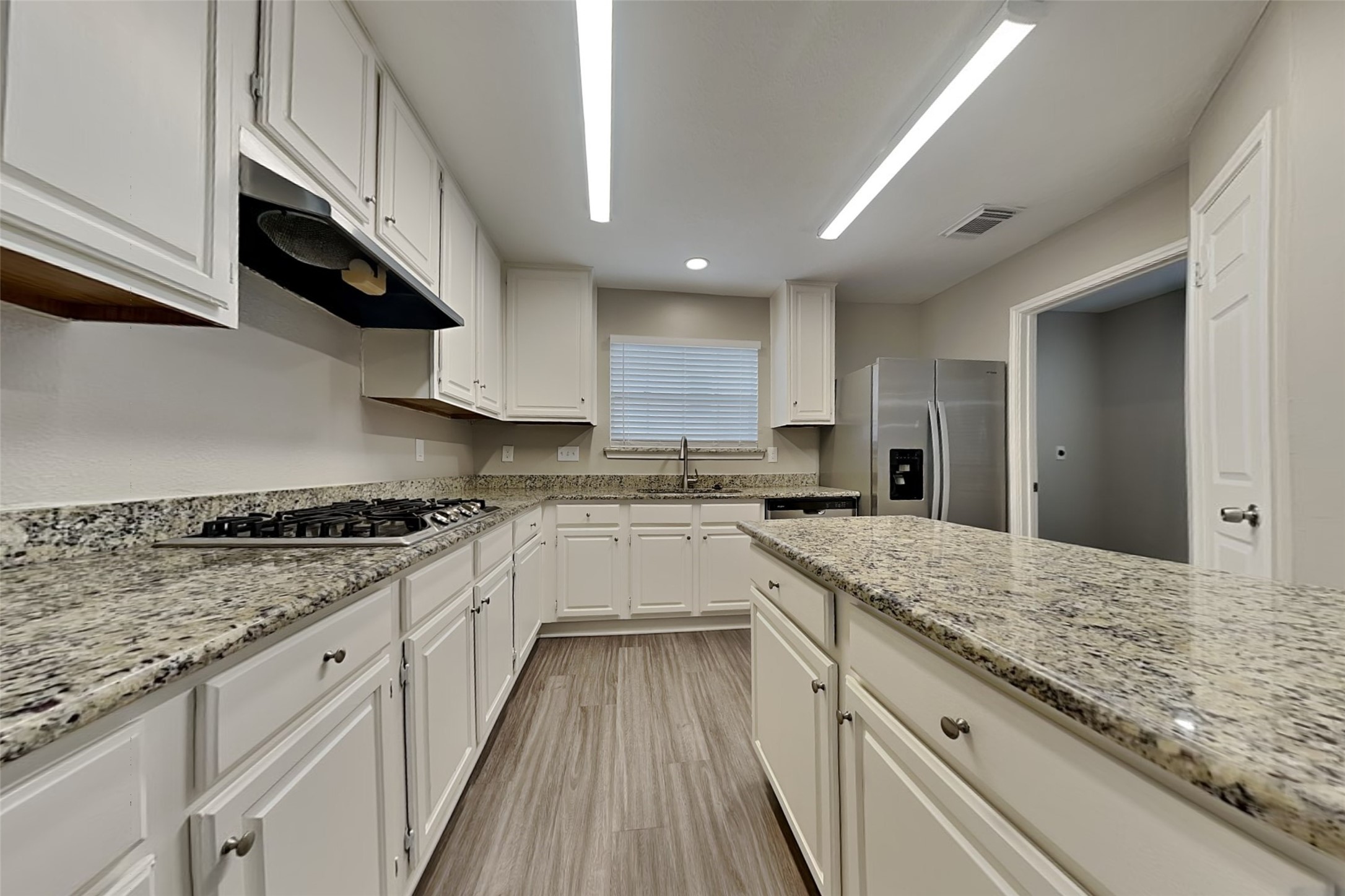 16910 Canyon Laurel Court Spring, TX 77379 - Photo 6 of 21 a kitchen with granite countertop kitchen island wooden cabinets and stainless steel appliances