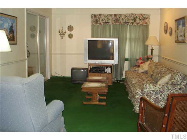 6240 Lookout Loop Raleigh, NC 27612 - Photo 12 of 19 a living room with furniture and a flat screen tv