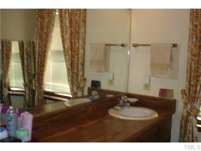 6240 Lookout Loop Raleigh, NC 27612 - Photo 14 of 19 a bathroom with a sink and a mirror