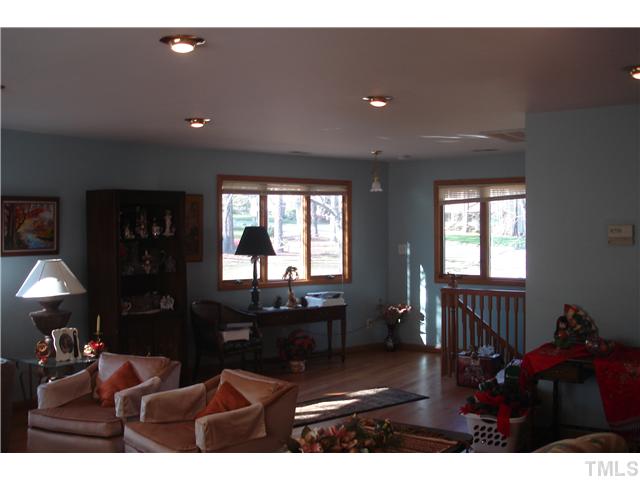6240 Lookout Loop Raleigh, NC 27612 - Photo 10 of 19 a living room with furniture a flat screen tv and a window