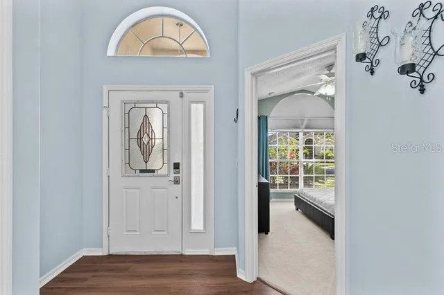 a view of a livingroom with wooden floor and a window