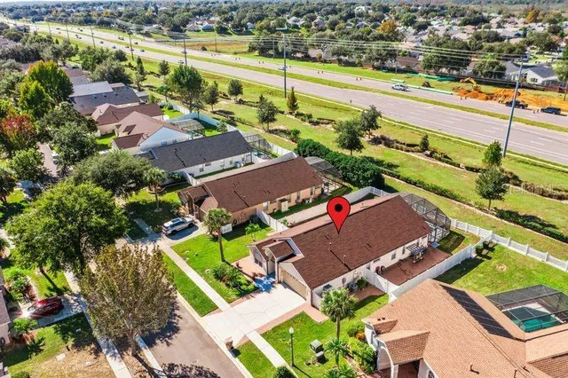 an aerial view of a house with a lake view