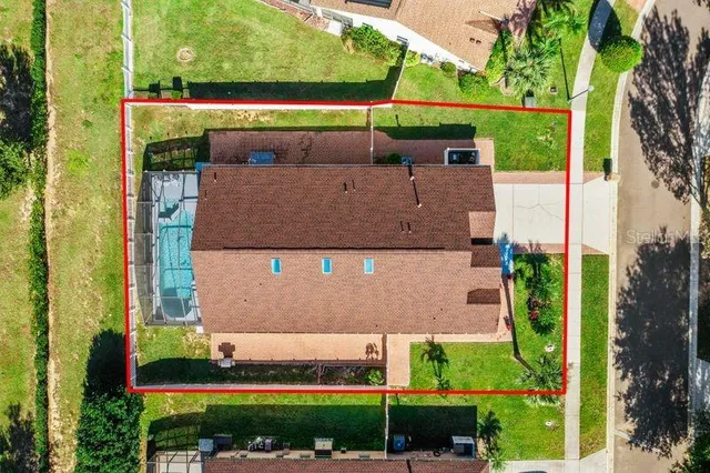 an aerial view of a house with a yard and potted plants