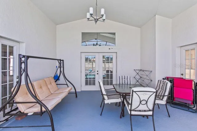 a view of a dining room with furniture wooden floor and a chandelier