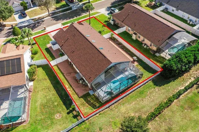 an aerial view of a tennis ground with a white house