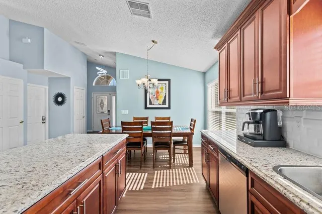 a kitchen with granite countertop lots of counter top space and dining table