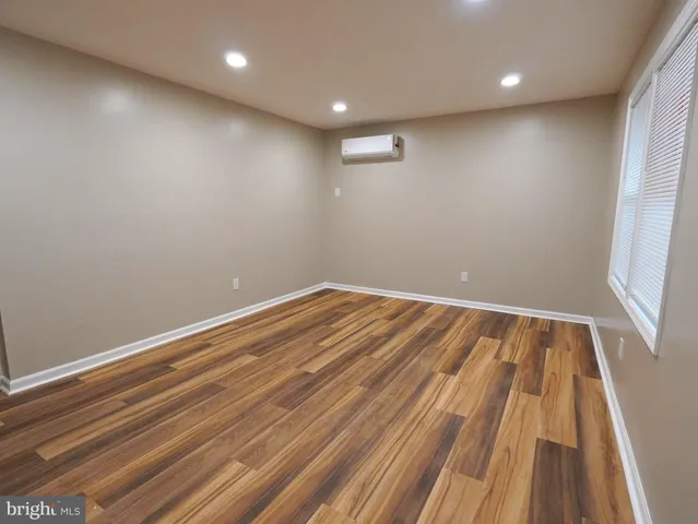 a view of room with wooden floor