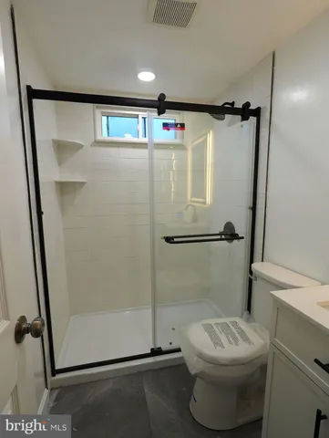 a bathroom with a shower and a toilet