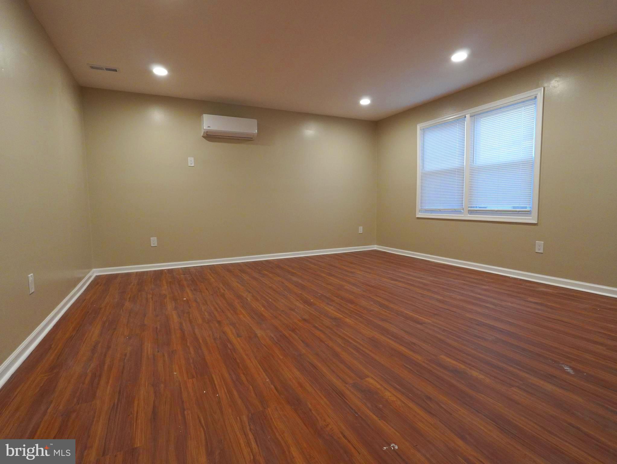 710 North York Road Willow Grove, PA 19090 - Photo 3 of 16 an empty room with wooden floor and windows