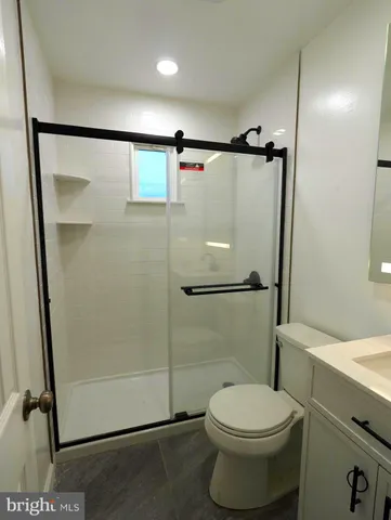 a bathroom with a toilet and a shower