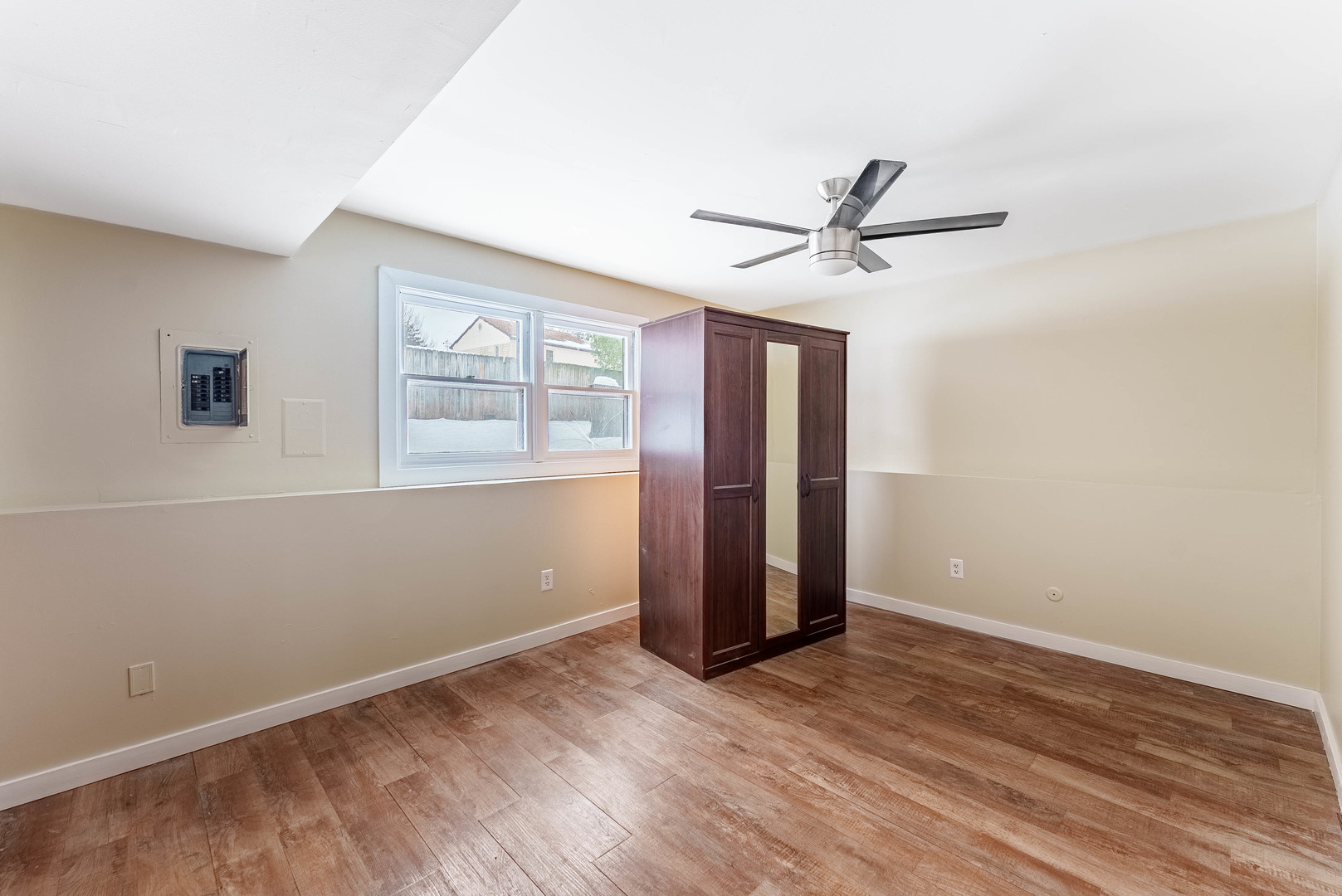 1359 Madison Court St. Charles, IL 60174 - Photo 16 of 23 an empty room with wooden floor and ceiling fan