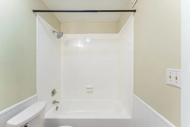 a bathroom with a shower and a bath tub