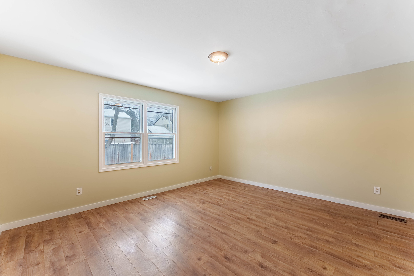 1359 Madison Court St. Charles, IL 60174 - Photo 6 of 23 a view of an empty room with wooden floor and a window