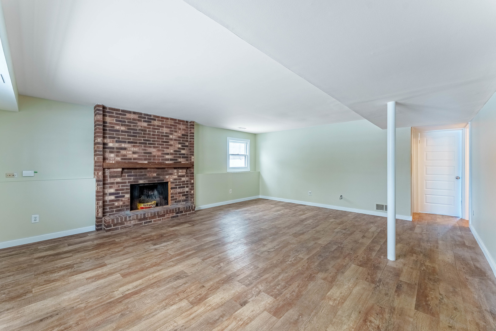1359 Madison Court St. Charles, IL 60174 - Photo 9 of 23 an empty room with wooden floor and fireplace