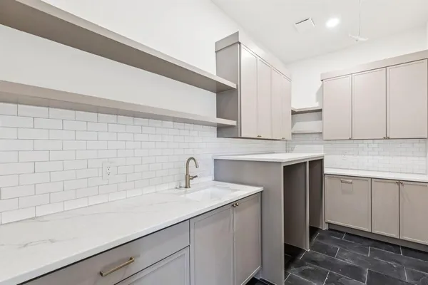 a kitchen with a sink cabinets and window