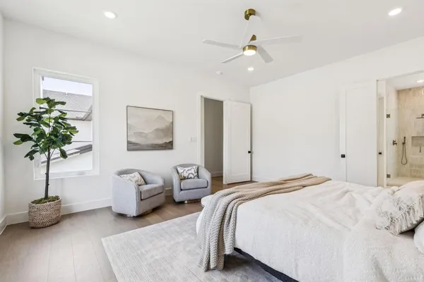 a bedroom with bed and a chandelier