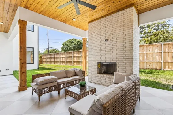 a balcony with furniture and a fireplace