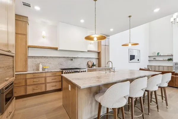 a kitchen with a table chairs stove and microwave