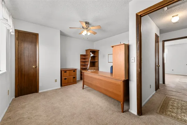 a bedroom with furniture and a ceiling fan