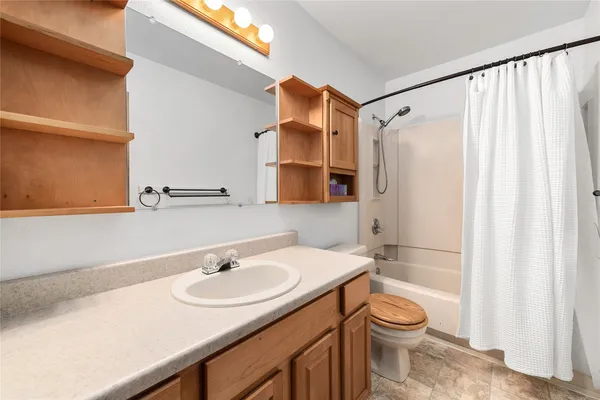 a bathroom with a sink toilet and shower