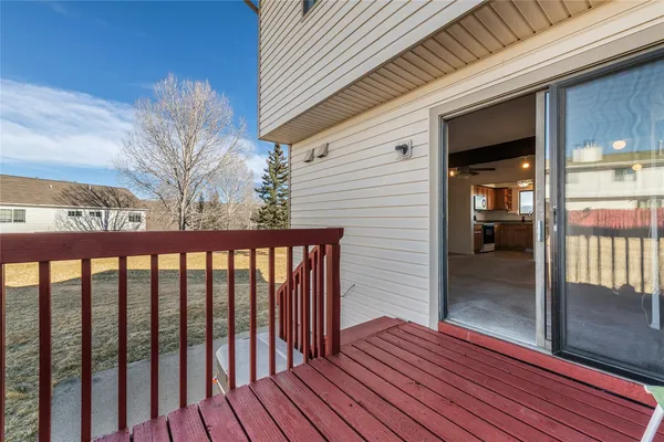 a view of a porch with wooden floor and stairs