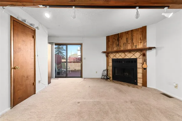 a view of an empty room with a fireplace