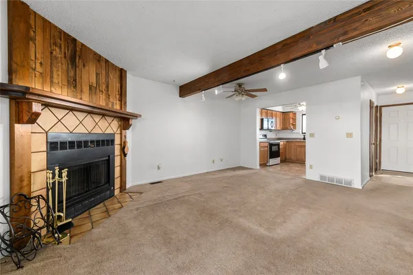 a view of empty room with a fireplace