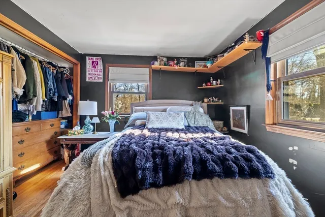 a view of a wooden deck with a large window and wooden fence