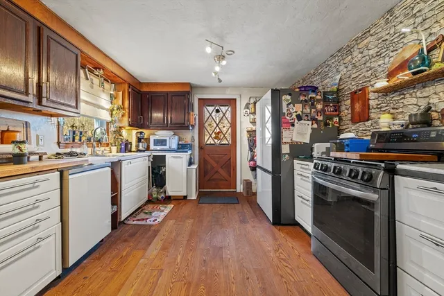 a bathroom with a granite countertop sink a toilet and a mirror