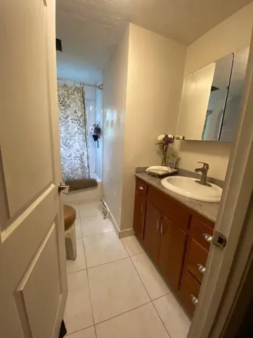 a view of a white house with a yard covered with snow