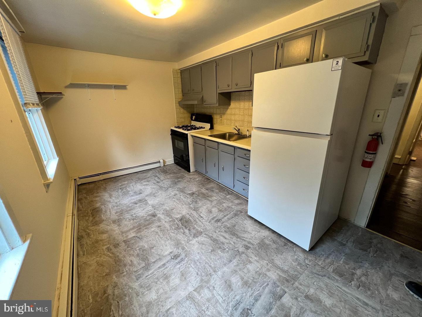 153 New Freedom Road Berlin, NJ 08009 - Photo 4 of 19 a white refrigerator freezer and a stove sitting inside of a kitchen