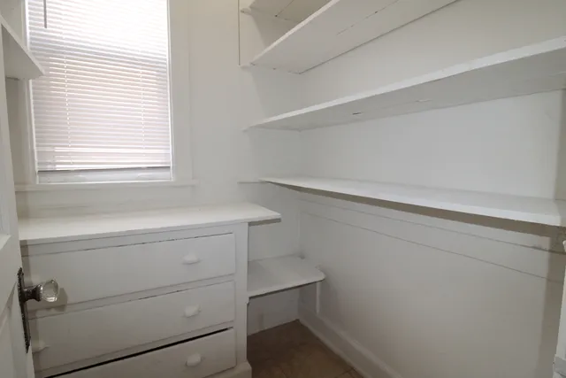 a view of storage and utility room with window