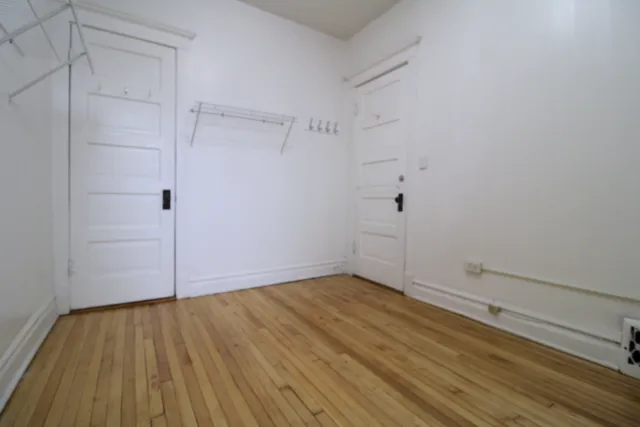 a view of a room with wooden floor