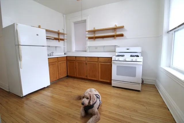 a kitchen with stainless steel appliances granite countertop a refrigerator sink and wooden floor