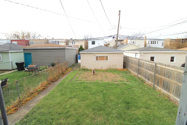 a view of a house with a yard and sitting area