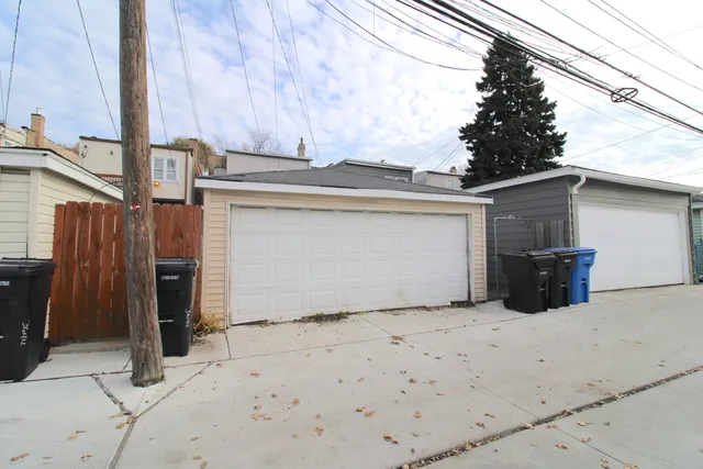 a view of garage with wooden fence