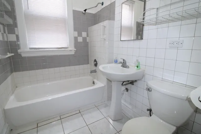 a bathroom with a sink a toilet and bathtub