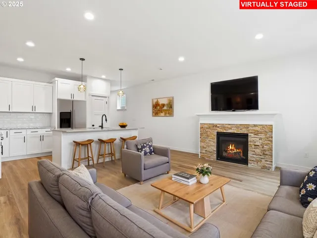 a living room with furniture a fireplace and a flat screen tv