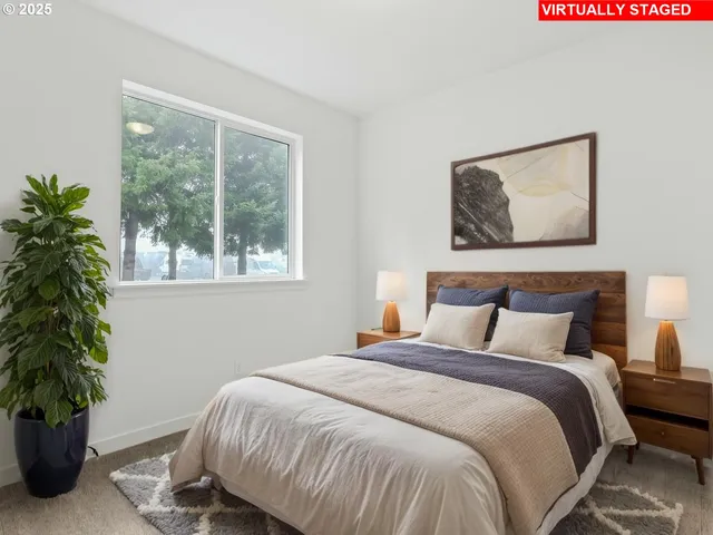 a bedroom with a bed and a potted plant