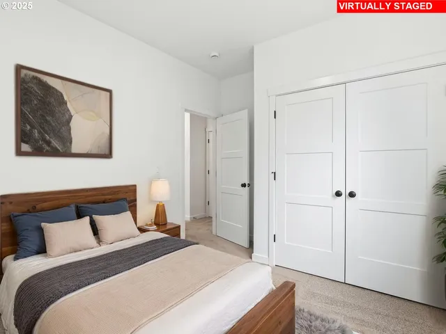 a bedroom with a bed and a painting on the wall