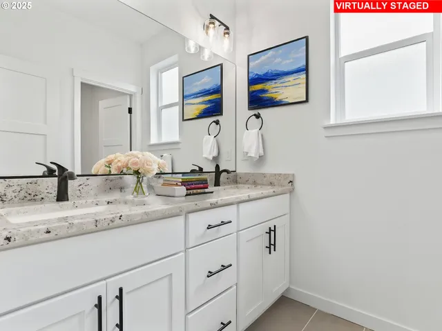 a bathroom with a granite countertop sink mirror and vanity
