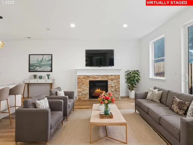 a living room with furniture a fireplace and a flat screen tv