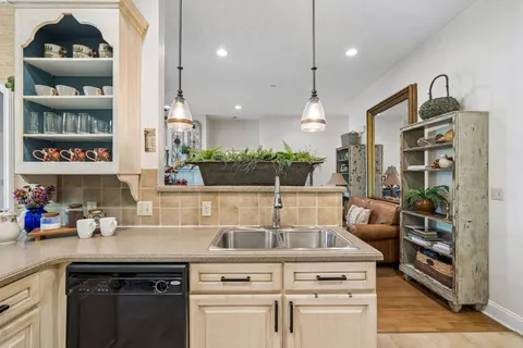 a kitchen with stainless steel appliances granite countertop a refrigerator sink and stove