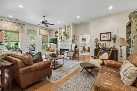 a living room with furniture ceiling fan and a rug
